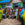Group of people gathered outside green building with blue roof (Hospital of Hope, Idjwi Island, DRC)