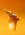 Iced coffee splashing out of the cup on an orange background