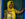 A picture of a coffee farmer from Rebuild Women's Hope Idjwi Island DRC, in a door way with a yellow scarf around her head