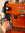 Close up of hand texturing milk at orange espresso machine in Mozzo's training room